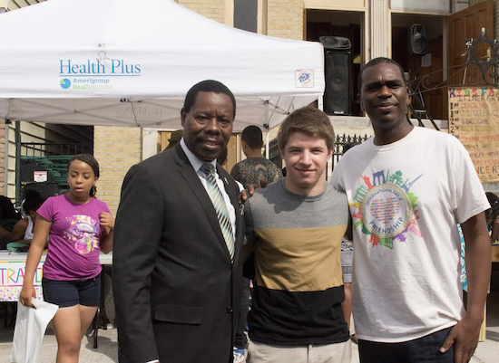City Councilmember Mathieu Eugene joins volunteer Jordan Linsker and Pastor Gilford Monrose at the Mount Zion Church-East 37th St. Block Party. Eagle photo by Francesca N. Tate