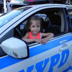 “Baby, you can drive my car,” the Beatles sang back in the mid-1960s. Little Emma Casella gets behind the wheel of a patrol car. Eagle photos by Paula Katinas