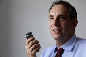 In this March 25, 2015 file photo, StoryCorps founder Dave Isay demonstrates how to record a story using a smartphone app in Brooklyn. StoryCorps wants tens of thousands of teenagers across the U.S. to interview a grandparent or elder this Thanksgiving and upload their recordings to the Library of Congress. AP Photo/Mark Lennihan, File