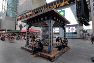 People sit on a large-scale art installation titled "Wishing on You," an interactive work by the Brooklyn-based artists Patrick McNeil and Patrick Miller known as FAILE, that was placed in Times Square on Monday. AP Photos/Richard Drew
