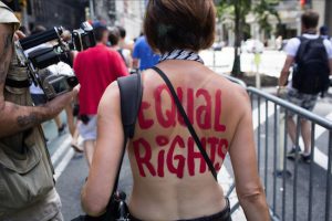 An activist marches in the GoTopless Day Parade on Sunday in New York. The parade took to the streets to counter critics who are complaining about topless tip-seekers in Times Square. AP Photos/Kevin Hagen