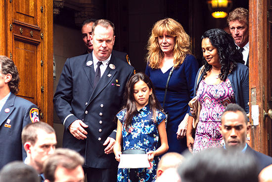 Firefighters and families of the fallen firefighters leave Assumption Church at the conclusion of the Remembrance Mass.