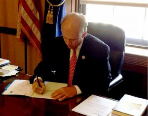 U.S. Rep. Dan Donovan signs an official notice authorizing his bill to be introduced in the House of Representatives.