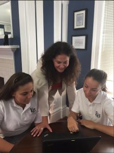 Principal Mary Ann Spicijaric, pictured giving two of her students a helping hand, says she’s exciting about Fontbonne Hall Academy’s new partnership with Brown University. Photo courtesy of Fontbonne Hall Academy