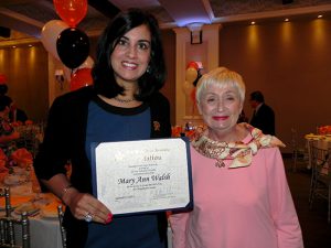 Assemblymember Nicole Malliotakis (left) presents Ragamuffin Parade Grand Marshal Mary Ann Walsh with a citation at a luncheon hosted by the parade committee.