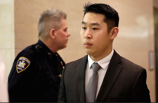 New York City rookie police officer Peter Liang, right, leaves the courtroom after his arraignment at Brooklyn Superior Court on Feb. 11. Liang, who fired into a darkened stairwell last November at a Brooklyn public housing complex, killing 28-year-old Akai Gurley, will go on trial in January. AP Photo/Mary Altaffer