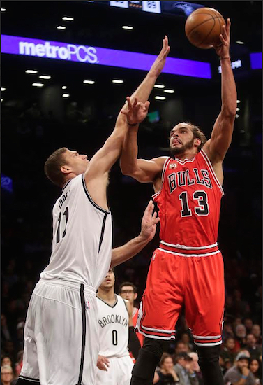 Brook Lopez rises to contest a shot from Poly Prep alum Joakim Noah during the Nets’ 115-100 Opening Night loss to Chicago at Downtown’s Barclays Center on Wednesday. AP photo