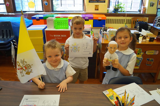 The students saluted Pope Francis with Vatican flags and a look-a-like doll. Photo courtesy of Saint Patrick Catholic Academy