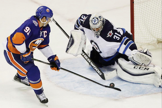 Team captain John Tavares sneaks one past Winnipeg goalie Ondrej Pavelec Monday afternoon as the Islanders celebrated Columbus Day with their first-ever victory at Downtown Brooklyn’s Barclays Center. AP photo