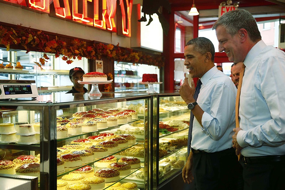 President Barack Obama and then-New York City Democratic Mayoral Candidate (now Mayor) Bill de Blasio visited Junior’s in Brooklyn on Oct. 25, 2013.  AP Photo/Charles Dharapak