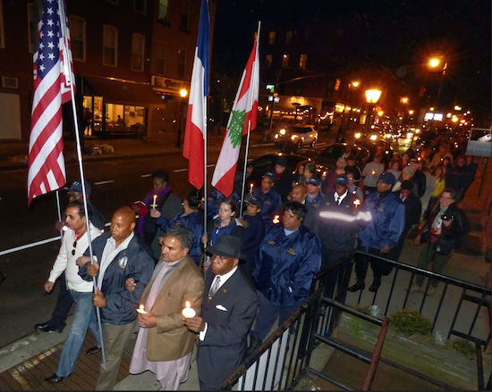 Brooklyn Borough President Eric Adams joined religious leaders and officials on a candlelight walk through Carroll Gardens Sunday night following a vigil in solidarity with the victims of terror attacks in Paris. Leaders flew the flags of the U.S., France, Kenya and Lebanon in memory of the victims of recent attacks around the world. Eagle photos by Mary Frost