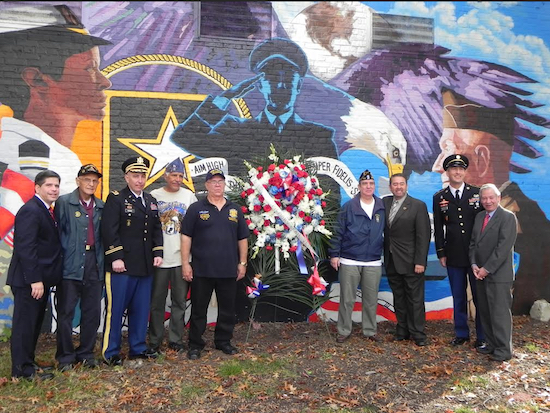 Councilmember Vincent Gentile (left) and Assemblymember Peter Abbate (right) join veterans after the laying of the wreath at the foot of the mural. Eagle photos by Paula Katinas