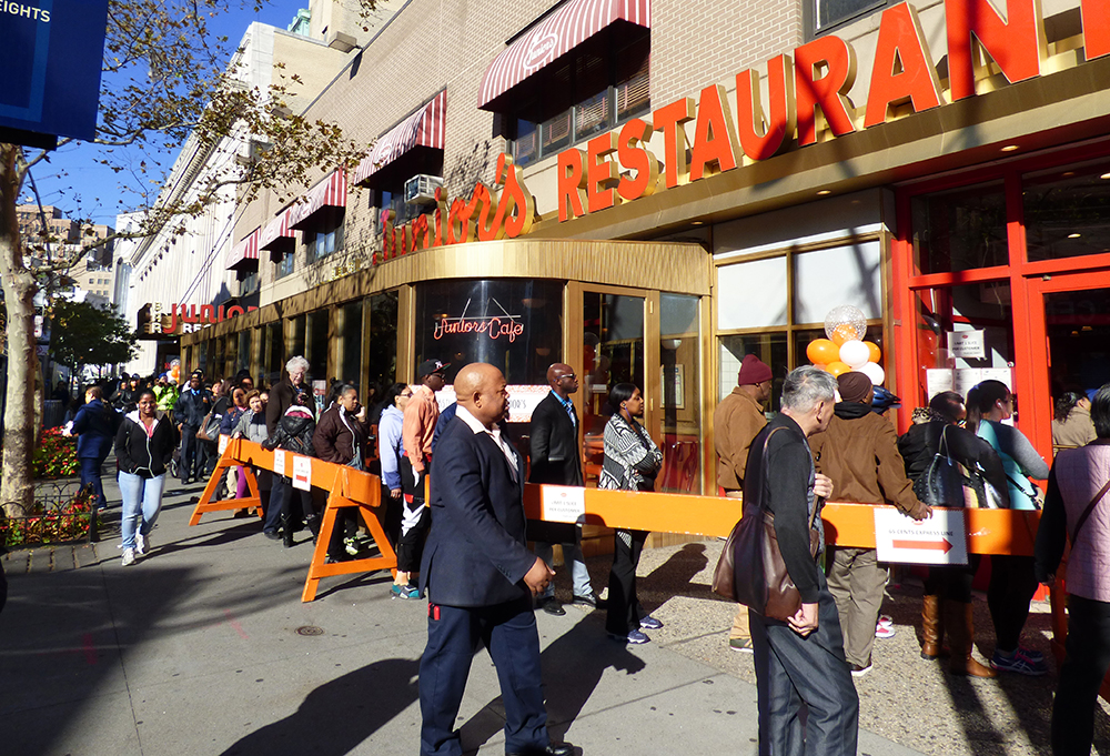 On Tuesday, customers at Junior’s restaurant in Downtown Brooklyn got a fat slice of the world’s most famous cheesecake for 65 cents, to celebrate the storied eatery’s 65th anniversary. The line snaked from Flatbush Avenue Extension down DeKalb.  Photo by Mary Frost