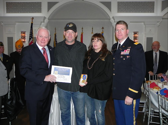 Kevin and Kim Sonko accept the New York State Liberty Medal from state Sen. Marty Golden (left) in memory of their son, U.S. Marine Corporal David Sonko. At right is Col. Joseph Davidson of Fort Hamilton. Eagle photos by Paula Katinas