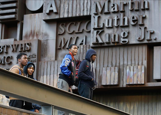 Students congregate on the steps of Martin Luther King Jr. High School on Manhattan's Upper West Side on Tuesday. Martin Luther King is one of 88 New York City schools requiring students to pass through metal detectors before entering. AP Photo/Kathy Willens