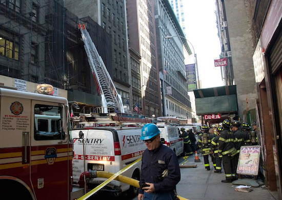 Firefighters gather at the site where a building being demolished to make way for a luxury boutique hotel partially collapsed in New York. On Saturday, Police identified the worker killed in the accident as Pedro Bacilio of Brooklyn. AP Photo/Bebeto Matthews, File