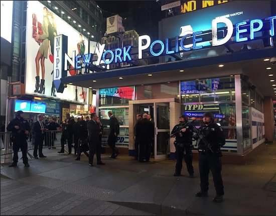 Police officers stand guard in Times Square on Wednesday. The NYPD says it's aware of a newly released Islamic State group video showing images of Times Square but says there's no current or specific threat to the city. AP Photo/Michael Balsamo