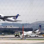 A United Airlines plane, top left, takes off from Newark Liberty International Airport. AP Photo/Julio Cortez