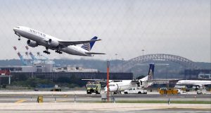 A United Airlines plane, top left, takes off from Newark Liberty International Airport. The Justice Department sued Tuesday to block a deal that would have allowed United Airlines to acquire 24 takeoff and landing slots at Newark. AP Photo/Julio Cortez