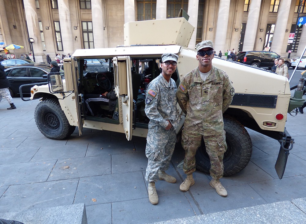 Sgt. Victor Morales from Fort Totton and Specialist Malik Ashby from Fort Hamilton guard a Humvee parked outside of Borough Hall.