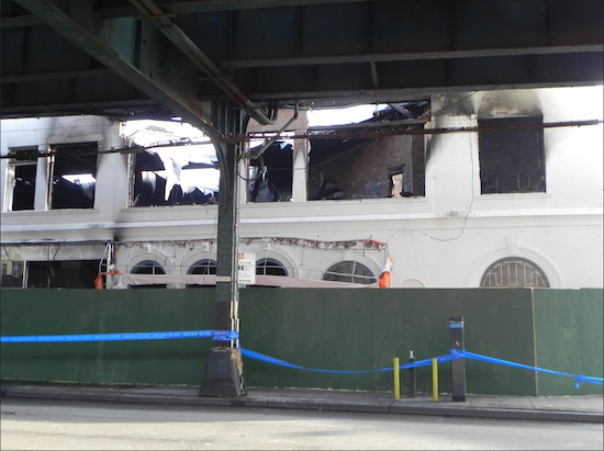 The fire destroyed the interior of the two-story building and disrupted service on the D train. Eagle photo by Paula Katinas