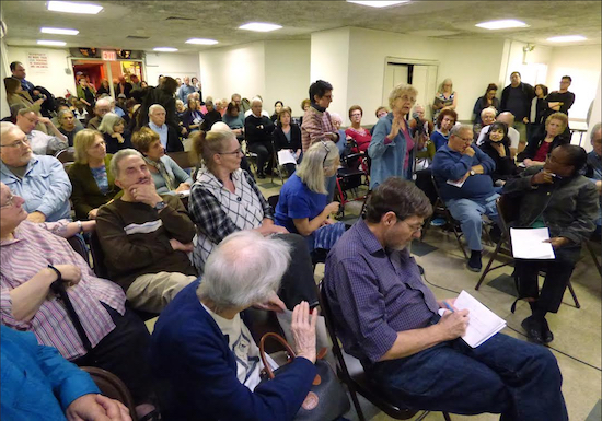 Residents of the Cadman Towers housing development crammed into the meeting room at 101 Clark St. in Brooklyn Heights Wednesday night for a meeting on what might be done to fight a high-rise tower proposed for Pineapple Walk. Eagle photo by Mary Frost