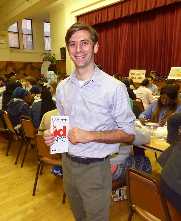 Councilmember Stephen Levin holds an example of some of the material available to immigrants who applied for citizenship at Saturday’s CUNY Citizenship Now outreach in Greenpoint. Roughly 130 applicants received free help. Photo by Mary Frost