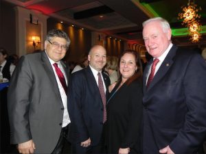 State Sen. Marty Golden (right) welcomed hundreds of guests to his Christmas Party, including Chief of Staff Gerard Kassar (left) and District 20 Community Education Council President Laurie Windsor and her husband Andrew Windsor. Eagle photo by Paula Katinas