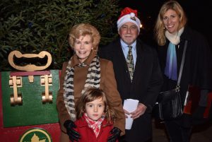 The 65th annual Christmas tree lighting ceremony was held on Montague Street at the Promenade entrance. Pictured from left are Sally Webb, president of the Brooklyn Heights Garden Club; 6-year-old Lulu Jane O’Tyson; Peter Bray, executive director of the Brooklyn Heights Association; and America Williamson, coordinator of the tree lighting ceremony. Eagle photos by Rob Abruzzese