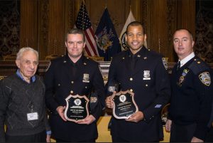 Officers John Condon (second from left) and Donovan Hunt (second from right) were honored as Cops of the Month by the 84th Precinct Community Council for all the work they’ve done in the pPrecinct community. Also pictured are Community Council President Leslie Lewis (left) and Deputy Inspector Sergio Centa. Eagle photos by Rob Abruzzese