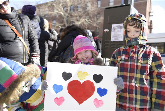 The Castellanos — Eva, Emilia and Luca (l. to r.) — display their artwork prior to marching on behalf of their Muslim neighbors in Bay Ridge. Eagle photos by Andy Katz