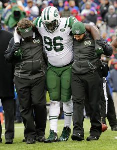 New York Jets defensive end Muhammad Wilkerson (96) is helped off the field during the second half of an NFL game against the Buffalo Bills on Sunday, Jan. 3, in Orchard Park, N.Y. AP Photo/Bill Wippert