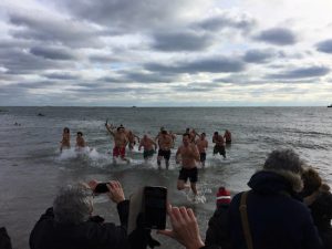 Brrrr, that’s cold! Braving the chilly waters, volunteers from DGK Holy Cross School take part in New Year’s Day plunge at Coney Island. Photos courtesy of Andrew Gounardes