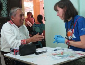 Dr. Stephanie Sterling, an infectious diseases physician at NYU Lutheran Medical Center, assists the village mayor in Guatemala, where her mission group, Global Penicilligirl, has traveled for the five years. Photo courtesy of NYU Lutheran