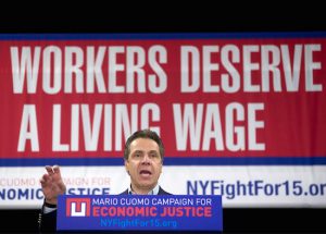 New York Gov. Andrew Cuomo speaks during a rally to raise the minimum wage on Thursday in Albany. Cuomo is continuing his push to raise the minimum wage to $15. AP Photo/Mike Groll