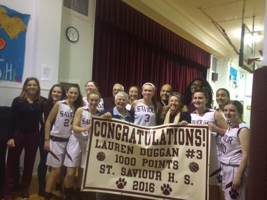 St. Saviour junior Lauren Duggan (Number 3) is surrounded by happy teammates and coaches after she reached a personal milestone in a game against Saint Vincent Ferrer High School. Photo courtesy of Assistant Coach Dan Texeira