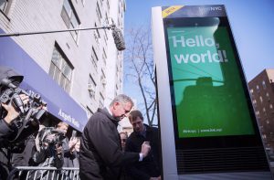 Mayor Bill de Blasio tries out the new LinkNYC Wi-Fi kiosk on Third Avenue in Manhattan on Thursday. Joining him are DoITT Commissioner Anne Roest, Scott Goldsmith of Intersection and a press scrum. Photo: Appleton/Mayoral Photography Office