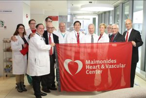 Members of the team responsible for the Maimonides Heart & Vascular Center present the flag in recognition of National Heart Month.  Photo courtesy of Maimonides Medical Center
