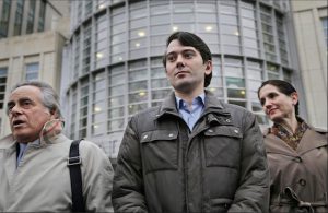 Former Turing Pharmaceuticals CEO Martin Shkreli, center, listens as his lawyer Benjamin Brafman, left, speaks to reporters as they leave court in Brooklyn on Wednesday. Shkreli, who has become the poster child of pharmaceutical-industry greed after hiking the price of an anti-infection drug by more than 5,000 percent, is scheduled to appear at a congressional hearing on Thursday. AP Photo/Seth Wenig
