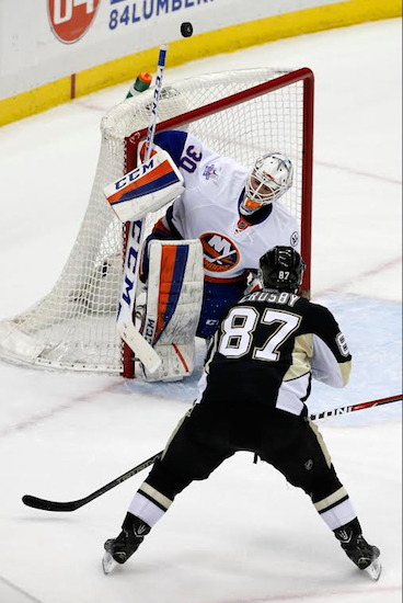 Rookie Jean-Francois Berube makes one of his 33 saves Tuesday night in Pittsburgh against Sidney Crosby as the Islanders picked up a big point in an eventual 2-1 shootout loss to the playoff-hopeful Penguins. AP photo