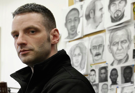 In this Wednesday, March 23 photo, Police Officer Matthew Klein poses for a picture at his desk in the NYPD Artist Unit in New York. There are only about 100 full-time forensic artists left in the U.S. Law enforcement officials say the work remains valuable because surveillance cameras and bystander cellphones can’t be everywhere and because crimes that are caught on video don’t always capture the suspect’s face. AP Photo/Seth Wenig