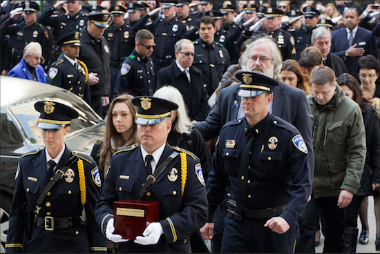 Marta Danylyk, second from left, arrives for the funeral Mass for her fiancé, Euless, Texas, Police Officer David Hofer, on Monday at St. Patrick's Cathedral in New York. Hofer was killed Tuesday, March 1, while responding to reports of shots fired in a park. Hofer was a 2008 graduate of New York University who served in the NYPD for five years before joining the Euless Police Department in 2014. AP Photo/Mark Lennihan