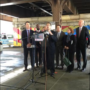 Elected officials and transportation advocates gather beneath the 125th Street Metro North station in Harlem to introduce Move NY Fair Plan legislation. Eagle photo by Sam Anderson