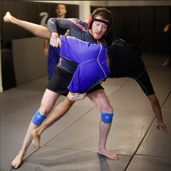 Sawyer Spielberg, left, takes down Antonio Sigillo at Radical MMA NYC, on Tuesday in New York. AP Photo/Mark Lennihan