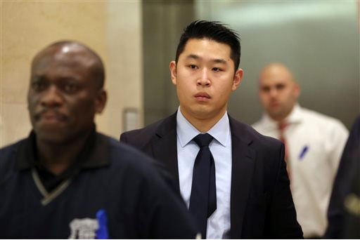 In a Feb. 9 file photo, Police officer Peter Liang, center, exits the courtroom during a break in closing arguments in his trial on charges in the shooting death of Akai Gurley, at Brooklyn Supreme court. Brooklyn DA Kenneth Thompson said Wednesday  that he has recommended that Liang serve no time behind bars. Liang was convicted of a manslaughter charge in February after the 2014 shooting death of Akai Gurley. The rookie officer was dismissed following the verdict. AP Photo/Mary Altaffer, File