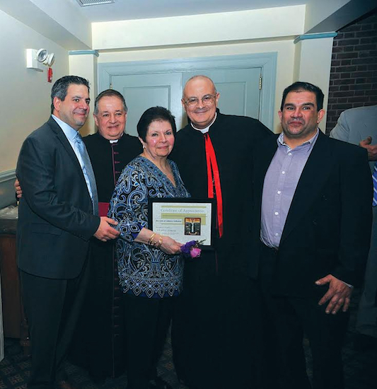 Phyllis Simon (center), her sons, Bishop Gregory Mansour (second from right) and Msgr. James Root (second from left). Simon, described as a tireless volunteer and a shining example of Maronite humility and kindness, received the Cathedral Lifetime Award.  Photo by World Photography