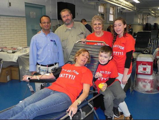 Christine Maxwell, sister of the late Mathiew Johnson, donated blood in her brother’s memory at last year’s blood drive. Also pictured are Mohammed Rahman, of the New York Blood Center; Maxwell’s father, Doug Johnson; her mother, June Johnson; and her children, Julia and Richard Maxwell. Eagle file photo by Paula Katinas
