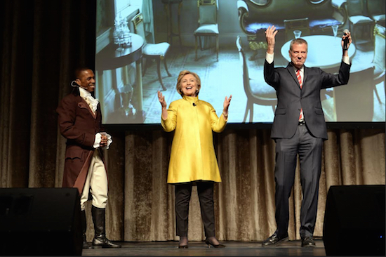Leslie Odum Jr., left, from the Broadway musical "Hamilton"; presidential candidate Hillary Clinton, center; and New York City Mayor Bill de Blasio, right, perform at the 94th annual Inner Circle Dinner in New York on April 9. Clinton and de Blasio have come under fire over their comedy skit at the show that some people feel was racially insensitive. David Handschuh/The Inner Circle Via AP, File