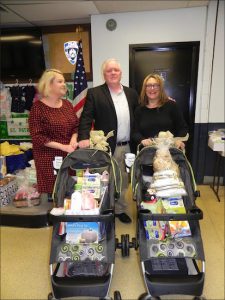 Community council leaders Kate Cucco (left), Dave Ryan and Ilene Sacco sorted through hundreds of baby gifts, including presents stored in strollers. Eagle photo by Paula Katinas