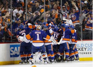 Fans react as New York Islanders celebrate eliminating the Florida Panthers 2-1 in second overtime period in Game 6 of an NHL hockey first-round Stanley Cup playoff series on Sunday. AP Photo/Kathy Willens